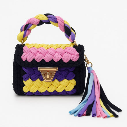Colorful braided handbag with a tassel on a white background
