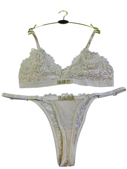 Beige lace bra and thong set on a white background