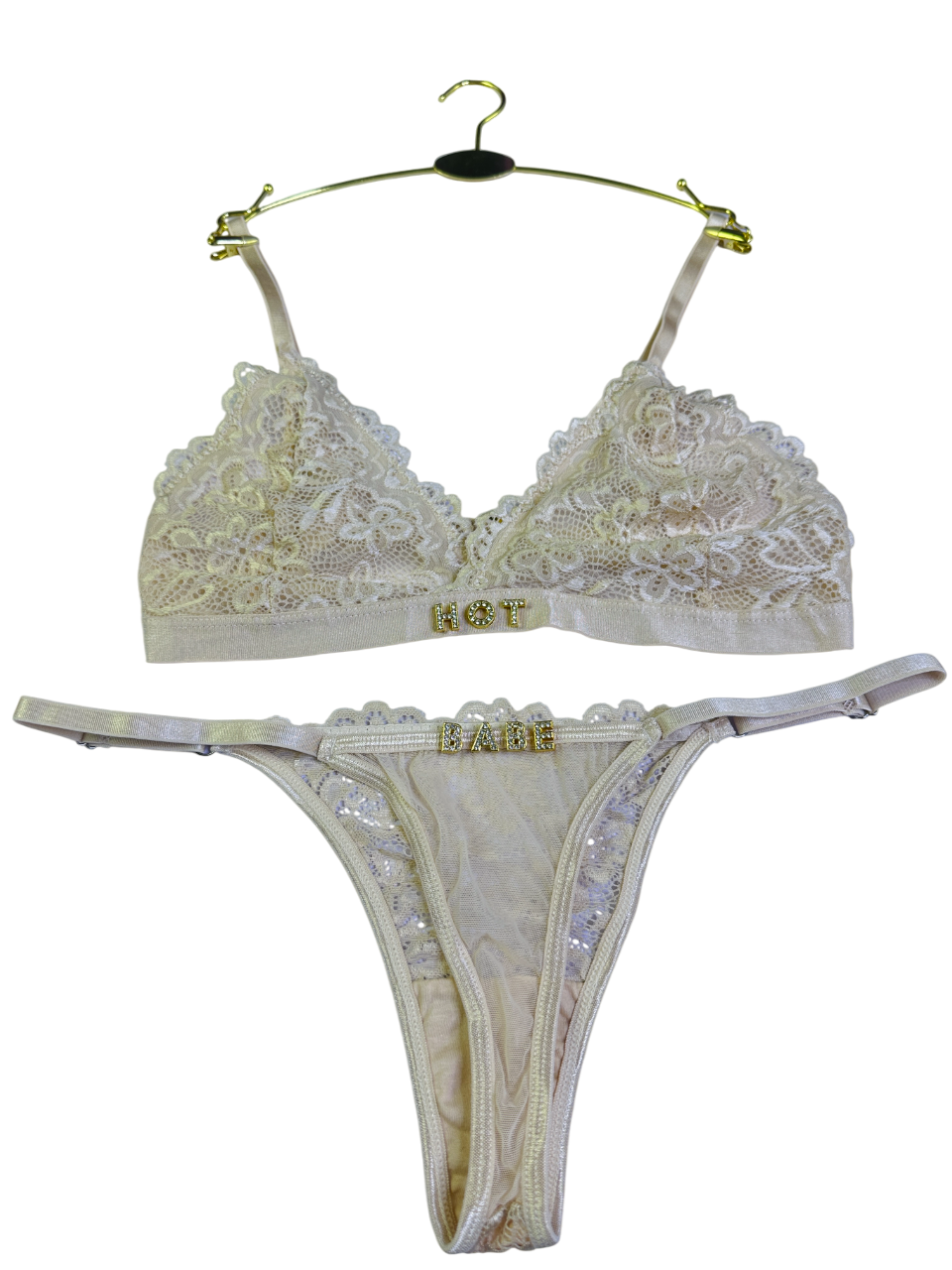 Beige lace bra and thong set on a white background