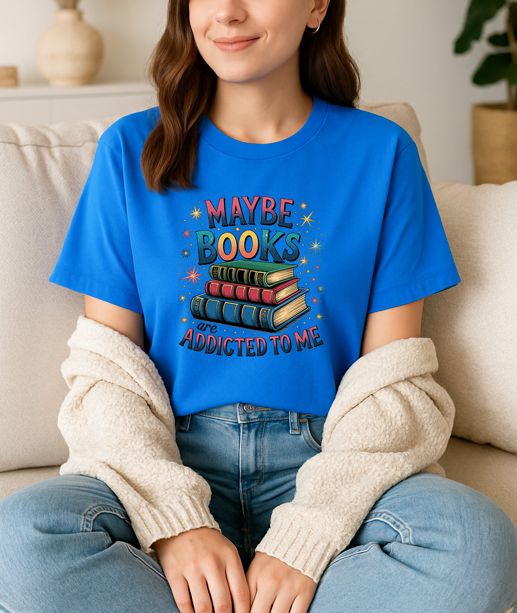 Woman wearing blue Maybe Books Are Addicted to Me graphic T-shirt, handmade organic cotton literary fashion tee for book lovers and readers.
