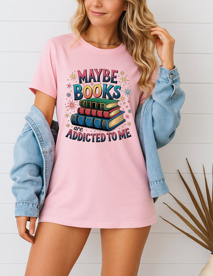 Woman wearing pink Maybe Books Are Addicted to Me graphic T-shirt, handmade organic cotton literary fashion tee for book lovers and readers.