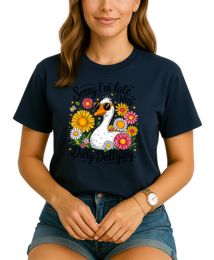 Person wearing a navy blue t-shirt with a swan and floral design, text 'Sorry I'm late. I was Dilly Dallying'.