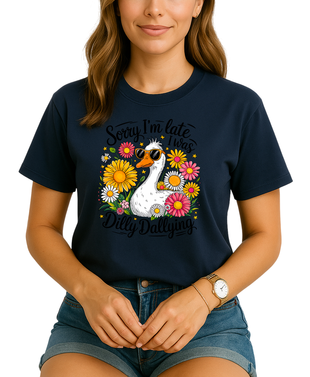 Person wearing a navy blue t-shirt with a swan and floral design, text 'Sorry I'm late. I was Dilly Dallying'.