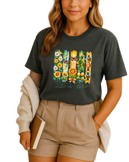 Woman wearing a black t-shirt with floral and butterfly design, holding a book.