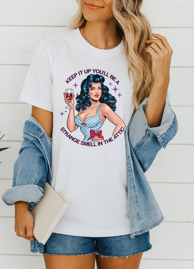 Woman wearing white retro pin-up graphic T-shirt with Keep It Up You’ll Be a Strange Smell in the Attic text, handmade organic cotton edgy fashion tee