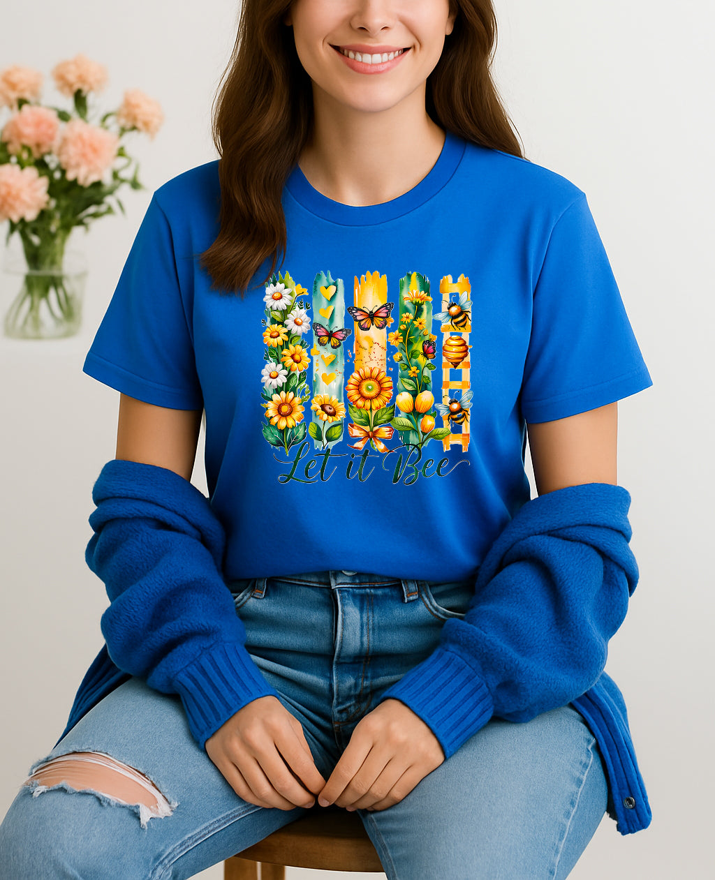 Woman wearing blue Let It Bee floral and bee graphic T-shirt, handmade organic cotton nature-inspired fashion tee with flowers and bees