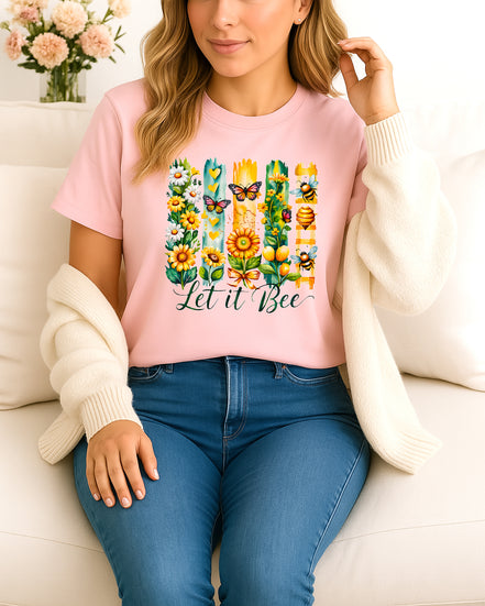 Woman wearing pink Let It Bee floral and bee graphic T-shirt, handmade organic cotton nature-inspired fashion tee with flowers and bees