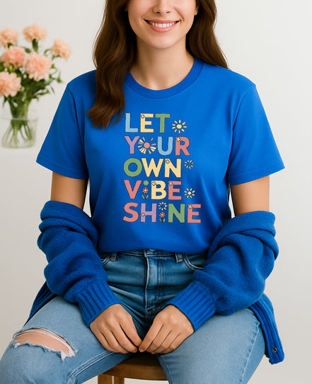 Handmade “Let Your Own Vibe Shine” graphic T-shirt, crafted from organic cotton. Colorful retro design to spread positivity and showcase your unique style.