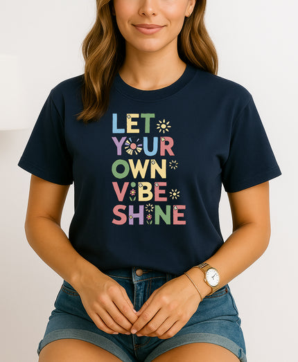 Handmade “Let Your Own Vibe Shine” graphic T-shirt, crafted from organic cotton. Colorful retro design to spread positivity and showcase your unique style.