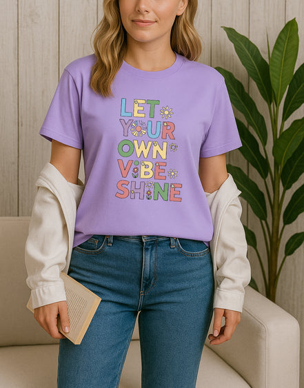 Handmade “Let Your Own Vibe Shine” graphic T-shirt, crafted from organic cotton. Colorful retro design to spread positivity and showcase your unique style.