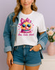Woman wearing white One Cute Chick graphic T-shirt with a chick in sunglasses blowing bubblegum, handmade organic cotton fun fashion tee