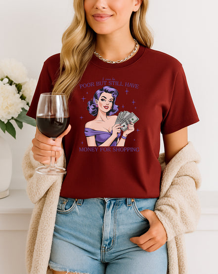 Woman wearing Maroon retro pin-up graphic T-shirt with I Can Be Poor But Still Have Money for Shopping text, handmade organic cotton fashion tee