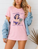 Woman wearing pink retro pin-up graphic T-shirt with I Can Be Poor But Still Have Money for Shopping text, handmade organic cotton fashion tee