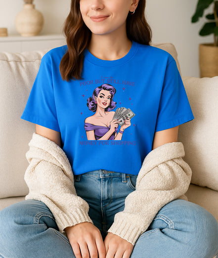 Woman wearing blue retro pin-up graphic T-shirt with I Can Be Poor But Still Have Money for Shopping text, handmade organic cotton fashion tee