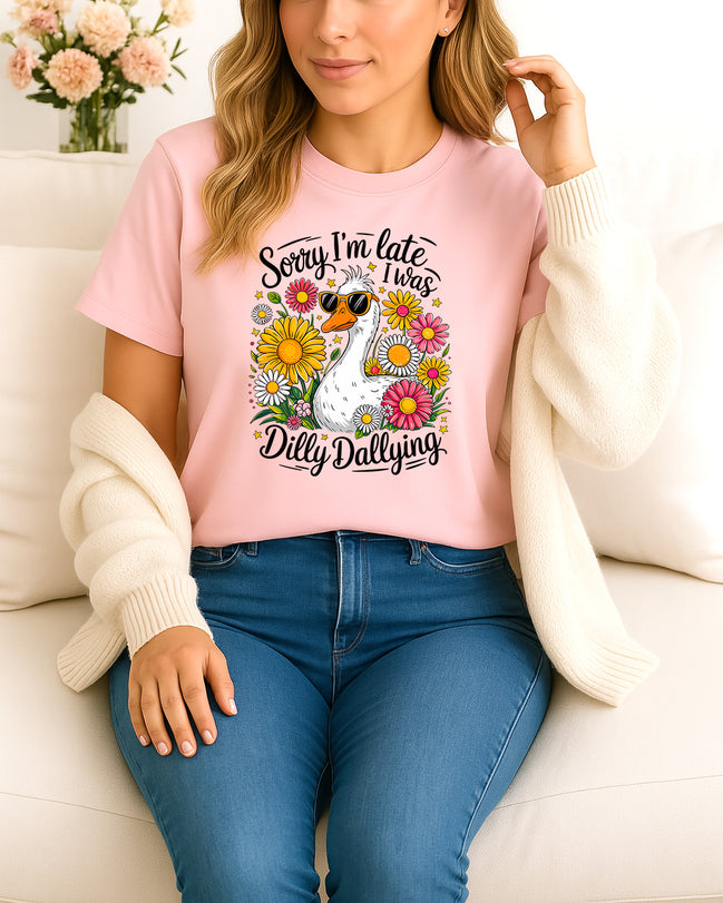 Woman wearing pink Sorry I’m Late I Was Dilly Dallying graphic T-shirt with duck and flowers, handmade organic cotton fun and casual fashion tee