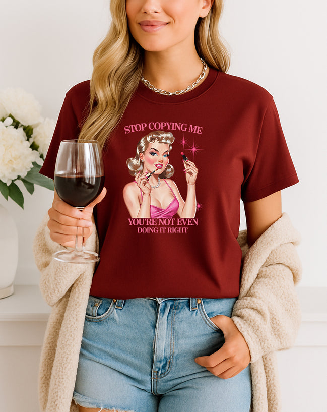 Woman wearing navy Stop Copying Me You’re Not Even Doing It Right retro pin-up graphic T-shirt, handmade organic cotton bold fashion tee