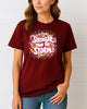 Woman wearing Maroon Stronger Than the Storm floral graphic T-shirt, handmade organic cotton empowering fashion tee