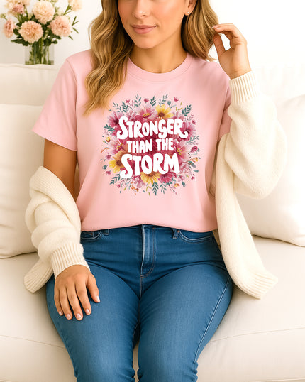 Woman wearing pink Stronger Than the Storm floral graphic T-shirt, handmade organic cotton empowering fashion tee