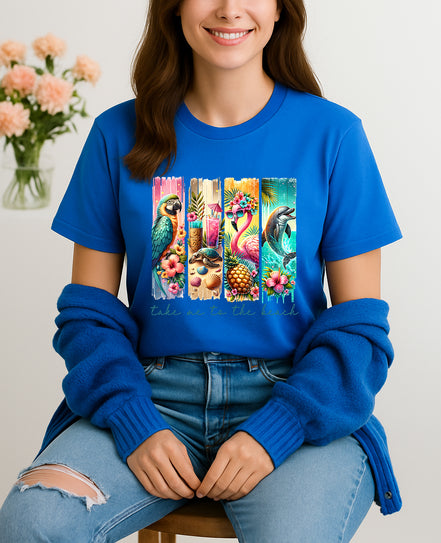Woman wearing blue Take Me to the Beach tropical graphic T-shirt with parrots, flamingos, and dolphins, handmade organic cotton summer fashion tee