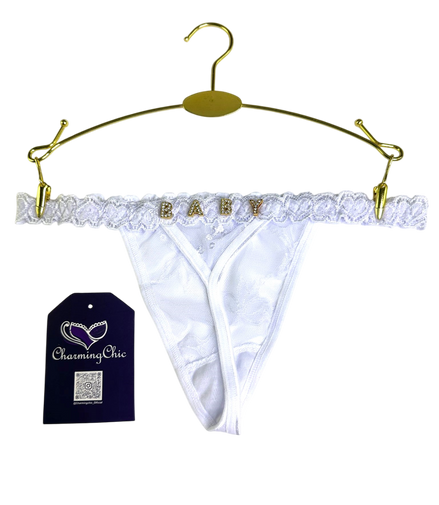 White lace babydoll panties on a gold hanger with 'Charming Chic' tag.