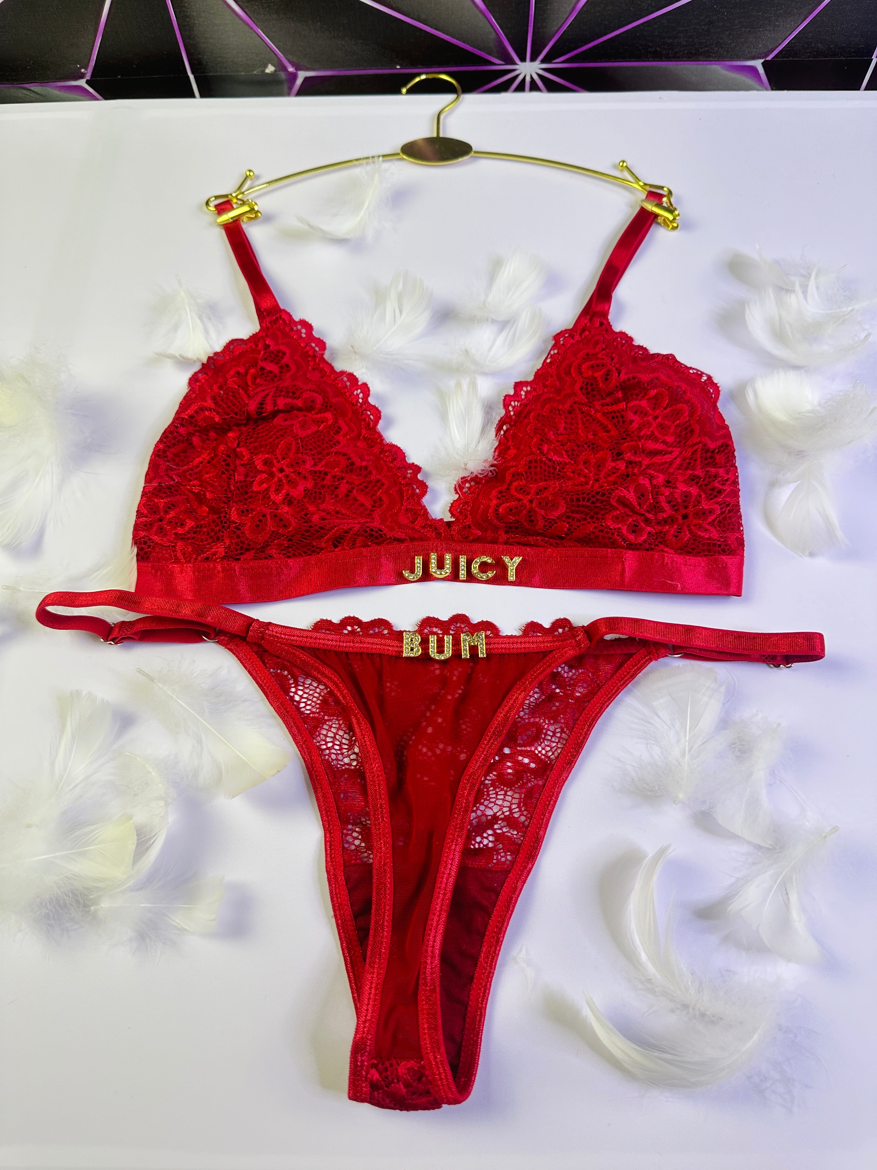 Red lace lingerie set with 'Juicy' branding on a white background