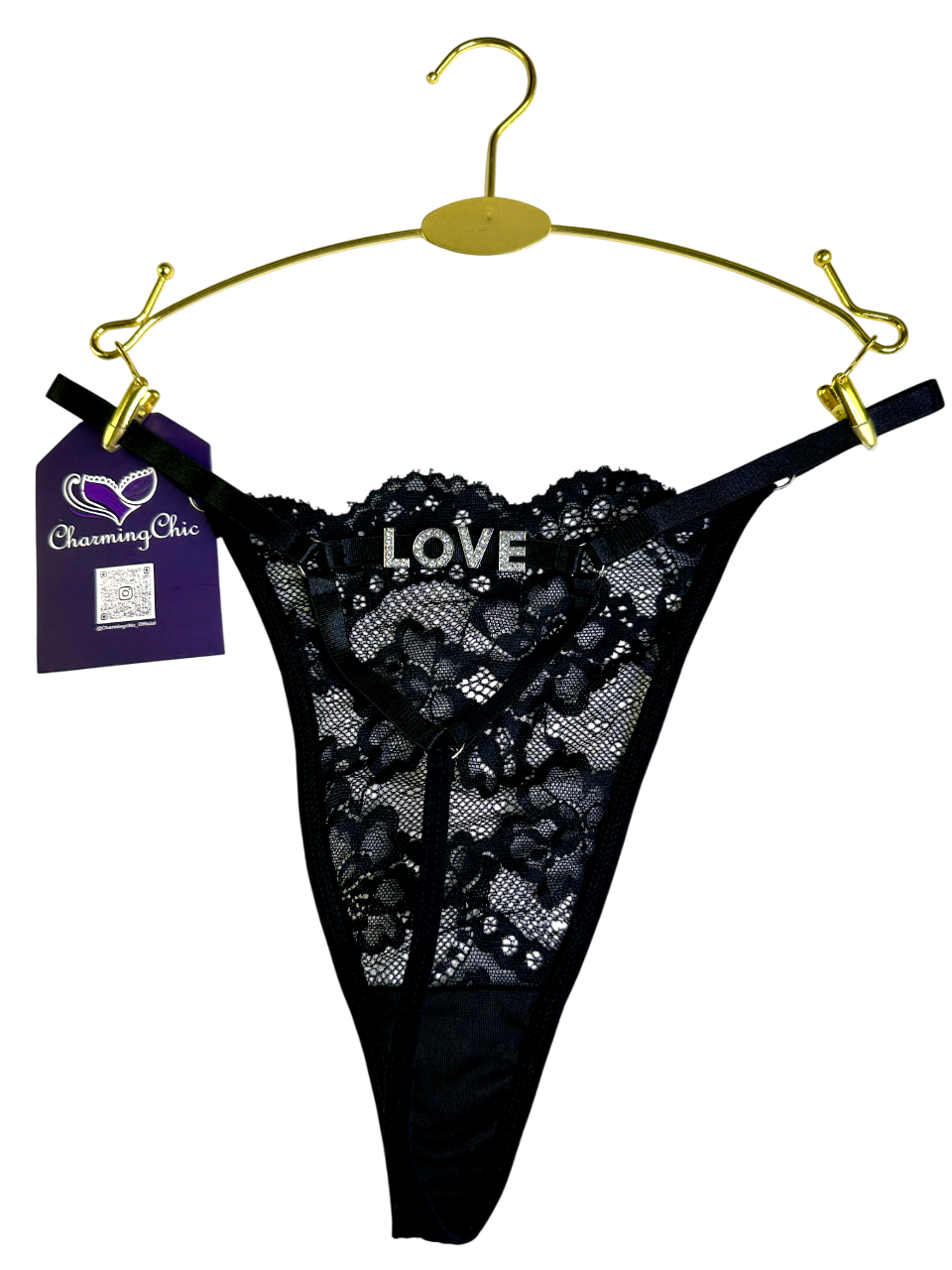 Black lace thong on a gold hanger with 'CharmingOlic' tag, on a white background