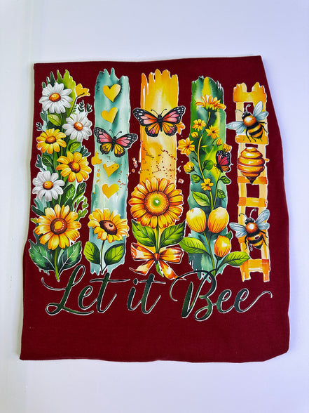 Decorative floral and bee tee design on a white background