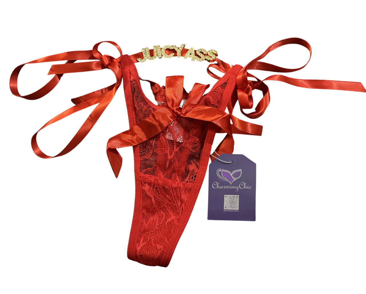 Red lingerie set with gold accents and red ribbons, featuring a purple tag, on a white background.