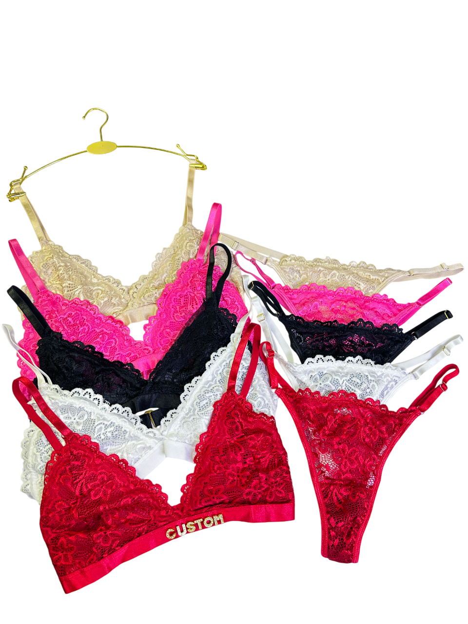 Set of colorful lace lingerie on hangers against a white background
