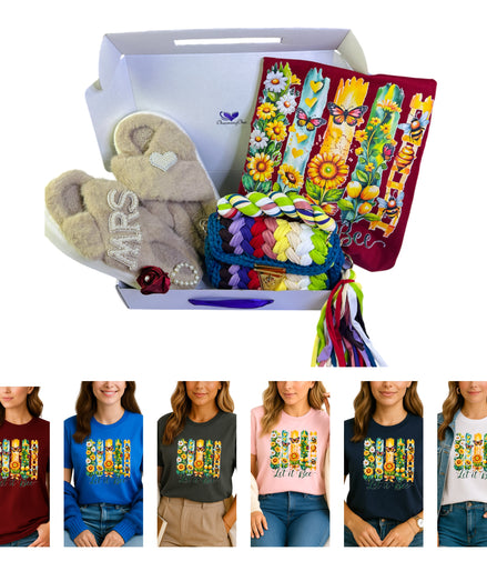 Gift box with plush toy, colorful bags, and t-shirts with floral designs and text.