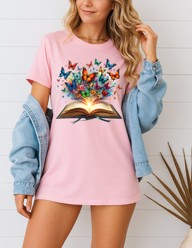 Woman wearing pink butterfly book graphic T-shirt, handmade organic cotton literary fashion tee, styled with denim jacket