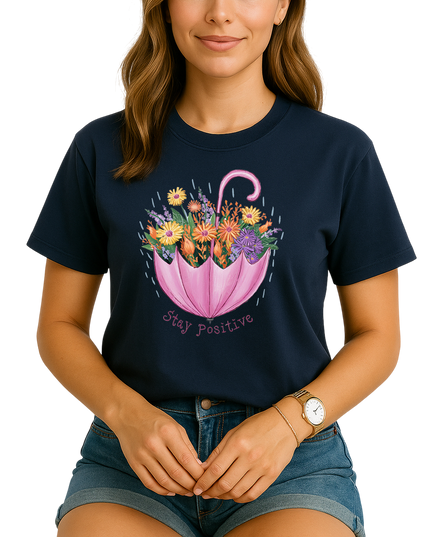 Woman wearing a navy blue t-shirt with a floral umbrella design and 'Stay Positive' text.